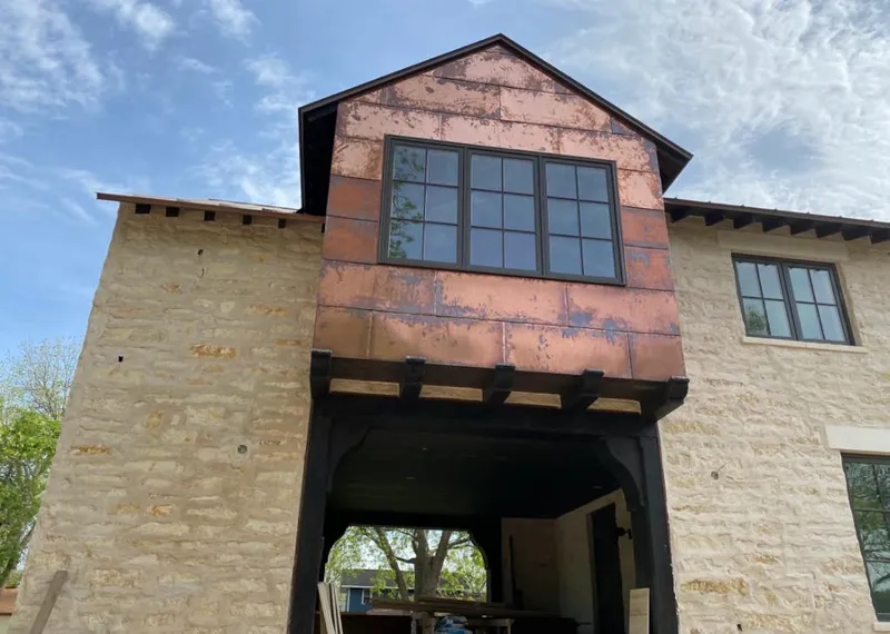 Copper metal panel facade on a stone building for Skylight Installation in Truckee